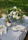 Large white and cream Haven centerpiece on blue tablecloth