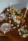 A large centerpiece from the Chelle collection on a rustic wood table