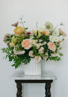 Medium Chelle centerpiece in white vase against white background on a gray marble tabletop