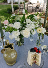Medium white and cream Haven centerpiece on blue tablecloth
